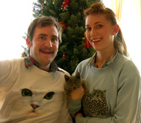holding their christmas kitty